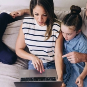 Family on a sofa using a laptop