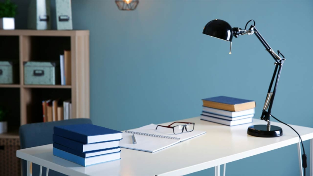 rendering of a desk with books and a lamp