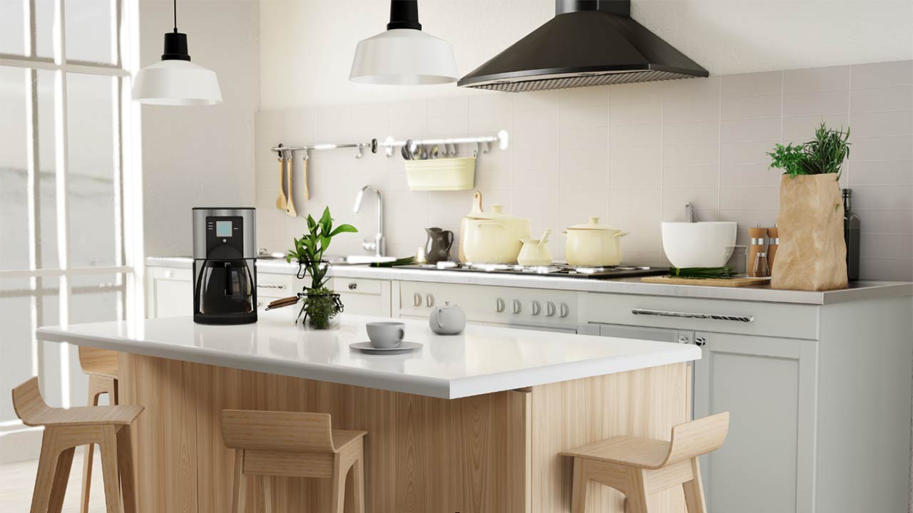 Image of a kitchen island with stools and a counter with a cook top in the background