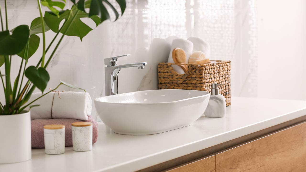 stylish vessel sink on light countertop in modern bathroom