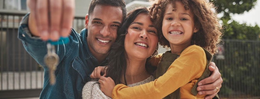 Happy family, portrait and real estate with keys in property, investment or new home together